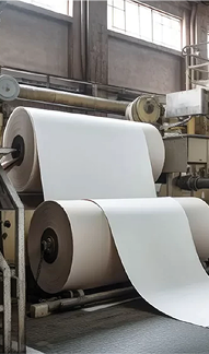 Large industrial rollers processing paper sheets